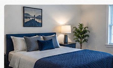 Representative comfortable bedroom with blue and neutral furnishings
